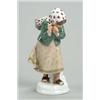 Image 1 : A Meissen figure of a girl, modelled hunched against a gust of wind and wearing winter clothes in...