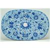 A Tendril pattern oval drainer, with decoratively shaped drainer holes, printed in blue with the...