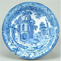 A blue-printed washbowl, decorated with a composite rural scene featuring a tower, a boy herding...