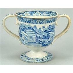 A blue-printed loving cup, of inverted baluster shape on pedestal foot with two simple loop handl...