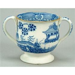 A small two-handled loving cup, of squat inverted baluster shape on a low pedestal foot, with och...