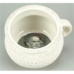 A small Belleek chamberpot commemorating Gladstone, the exterior moulded with bands of scrolls an...