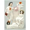 Image 1 : A spill vase group of a traveller and companion, modelled resting beside a milestone, moulded in...