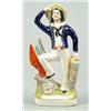 Image 1 : A figure of a British sailor, modelled standing with one foot raised on a cannon, partially colou...
