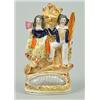 Image 1 : A group of a sailor and companion, perhaps theatrical, modelled clinging to rocks above an upturn...