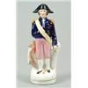 Image 1 : A figure of Admiral Lord Nelson, modelled standing before an anchor, leaning on a sword, his hat...