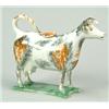 Image 1 : A pearlware cow creamer and cover, typically modelled standing on a shaped rectangular green-glaz...