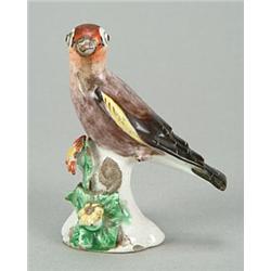 A Derby model of a goldfinch, perched on a flower-encrusted base, painted with coloured enamels,...