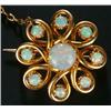 Image 1 : An Edwardian gold and opal brooch of spiral cluster design set with nine round white opal cabocho...
