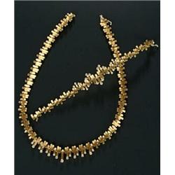 A Continental diamond fringe necklace and a matching bracelet, each composed of yellow metal sati...