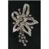 Image 1 : A diamond spray brooch with a central flower-head cluster within a leaf and ribbon loop surround,...