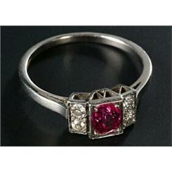 A pink sapphire and diamond dress ring, centred with an oval mixed-cut bright pink sapphire, appr...