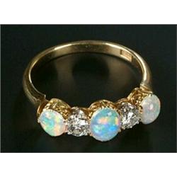 An Edwardian gold, opal and diamond five stone ring, the three oval white opals spaced by early m...