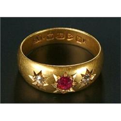 An Edwardian 18ct gold, ruby and diamond three stone gypsy ring, centred with a round mixed-cut r...