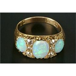 A late Victorian gold, opal and diamond carved half-hoop ring, the three oval white opals with ol...