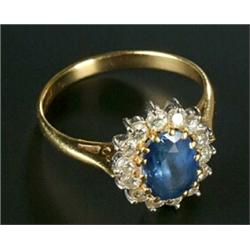 An 18ct gold, sapphire and diamond oval cluster ring, centred with an oval mixed-cut sapphire wit...