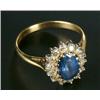 Image 1 : An 18ct gold, sapphire and diamond oval cluster ring, centred with an oval mixed-cut sapphire wit...