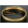 Image 1 : A Victorian gold bangle, the front with a central row of oval and beaded decoration, (see illus...