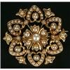 Image 1 : An Edwardian gold and half-pearl brooch centred with a flower-head within an open hexafoil border...