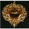 Image 1 : A 19th century gold and citrine cannetille brooch, the shaped-oval panel centred with an oval mix...