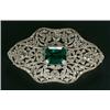 Image 1 : An Edwardian diamond and imitation emerald cartouche shaped brooch, designed as an openwork panel...