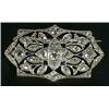 Image 1 : An Edwardian sapphire and diamond brooch, the shaped oblong panel with a central diamond quatrefo...