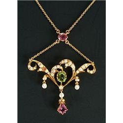 An Edwardian gold, half-pearl, peridot and pink tourmaline necklace, of openwork scroll design wi...