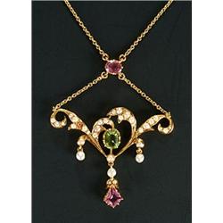 An Edwardian gold, half-pearl, peridot and pink tourmaline necklace, of openwork scroll design wi...