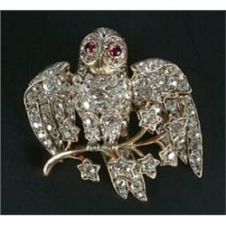 A late Victorian diamond brooch in the form of an owl standing on a branch, set throughout with o...