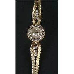 Omega, a lady's 18ct gold and diamond round bracelet watch, circa 1960, no.48529, silvered dial w...