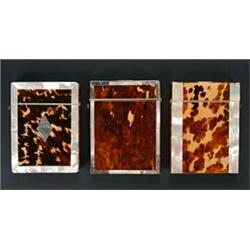 Three tortoiseshell and mother of pearl card cases, each with central tortoiseshell panels with m...