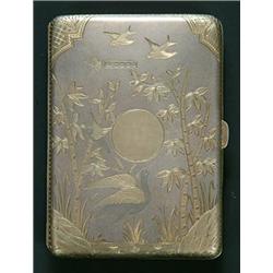 A late Victorian silver gilt aide memoire, decorated in aesthetic taste with exotic birds amidst...