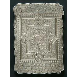 A Victorian silver card case of shaped outline, centrally engraved with round reserves with eithe...