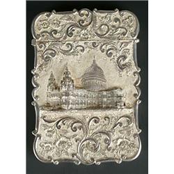 A Victorian silver 'castle top' card case of shaped outline, chased with a view of St Pauls Cathe...