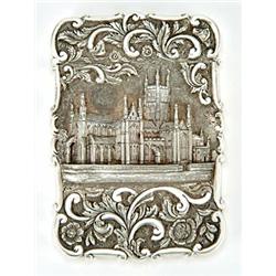 A Victorian silver 'castle top' card case, of shaped outline, the front chased with a view of Wor...