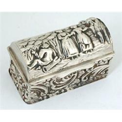 A silver chest-shaped ring box for three rings, the hinged cover embossed with figures, the sides...