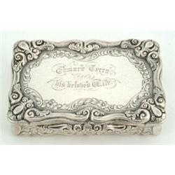 A Victorian rectangular snuff box with shaped and foliate engraved sides and base and a leaf and...