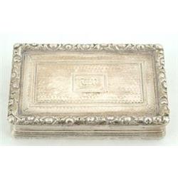 A George IV rectangular snuff box, engine turned with floral chased borders and concave reeded si...