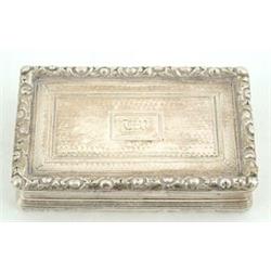 A George IV rectangular snuff box, engine turned with floral chased borders and concave reeded si...