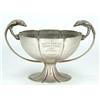 Image 1 : A fluted round bowl of hammered form with two chased eagle shaped handles on a trumpet shaped foo...