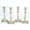 Image 1 : A set of four late George II cast candlesticks, each with a leaf chased knopped stem, round capit...