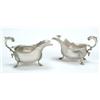 Image 1 : A pair of sauceboats, with shaped rims, leaf capped flying scroll handles and hoof feet, retailed...