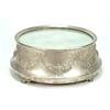 Image 1 : A round cake-stand with a mirrored top and tapered sides embossed with floral swags and ribbon ti...