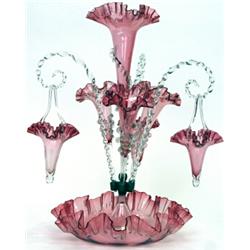 A late Victorian ruby tinted glass épergne, circa 1900, the central flared vase above three branc...