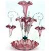 Image 1 : A late Victorian ruby tinted glass épergne, circa 1900, the central flared vase above three branc...