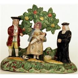A Staffordshire pottery tithe group, circa 1830, modelled with vicar, man and lady holding baby,...