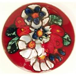 A Poole pottery bowl, 1960's, brightly enamelled with stylised sprays on a red ground within a wh...