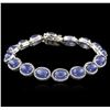 Image 1 : PLATED SILVER 28.60ctw Tanzanite and Topaz Bracelet