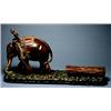 An Asian Carved Hardwood Group, Mid 20th century, Depicting a logging scene with a man raised on...