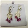 Image 1 : ONE PAIR OF 14KT YELLOW GOLD RUBY BRIOLETTE DANGLING EARRINGS. FLEUR DE LIS FRONT, AND A SCROLL AND